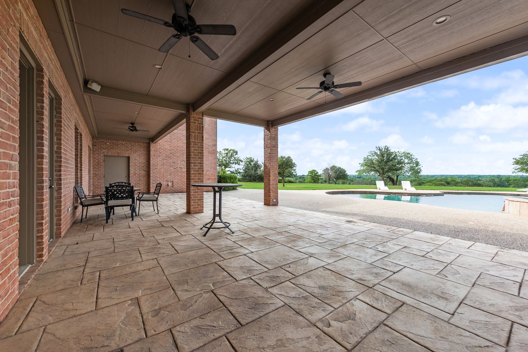 Covered veranda overlooking the pool and grounds
